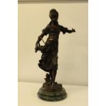 A very heavy leaded bronze sculpture on a marble base of a young woman carrying a basket of flowers.