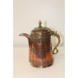 An ornately embossed antique 19th century Middle eastern copper jug. (Some dents) h30cm