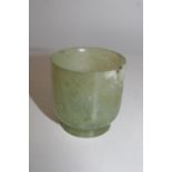 An antique Chinese green jade tea bowl (small chip to the rim)