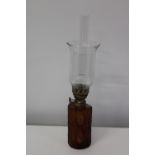 An unusual oil lamp with an amber glass reservoir h44cm
