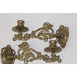 A pair of antique brass swivel candlesticks (from a piano)