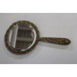 A antique gilt metal hand mirror with bevelled edged glass w25cm