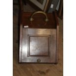 An oak and brass coal scuttle with liner