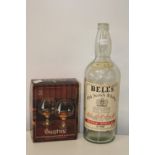 A large empty Bell's whisky bottle and set of new glasses