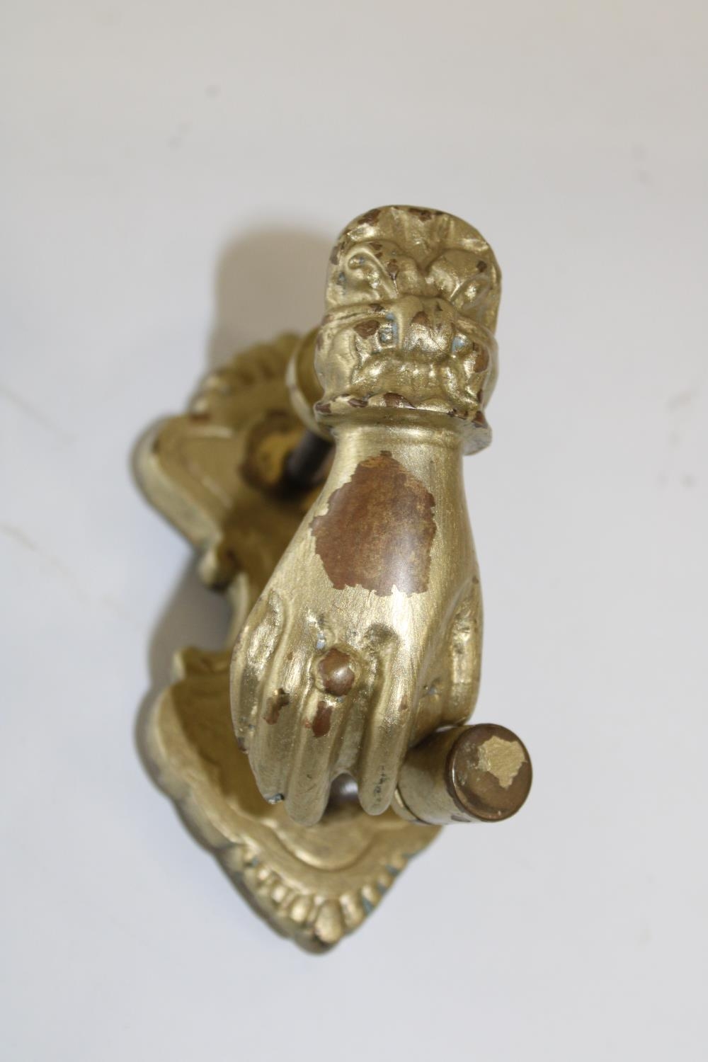 A heavy brass Victorian door knocker