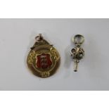 A 9ct gold three lions pocket watch fob & 9ct gold pocket watch key. Total weight 7.8 grams