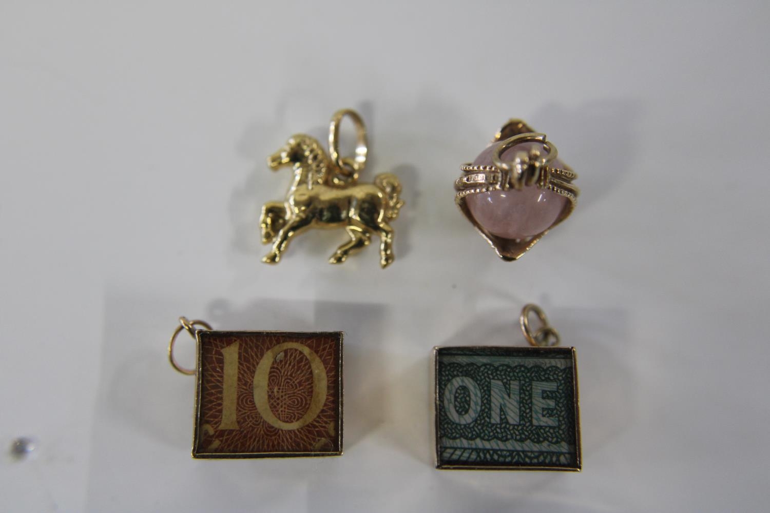 Four 9ct gold charms 9.0 grams total weight