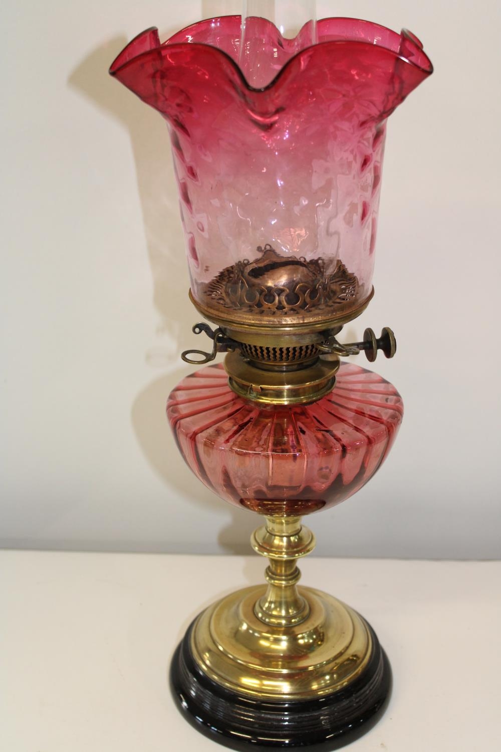 A Hink's duplex pink glass oil lamp. Height 56cm