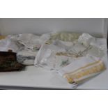 A box of vintage linen & table clothes etc
