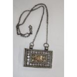 An usual white metal amulet on chain