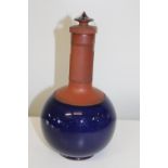 A Chinese Yixing bottle vase with a deep blue glaze & stopper. Height 23cm