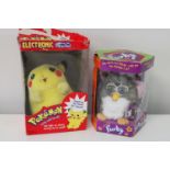 A boxed Pikachu & Furby toy