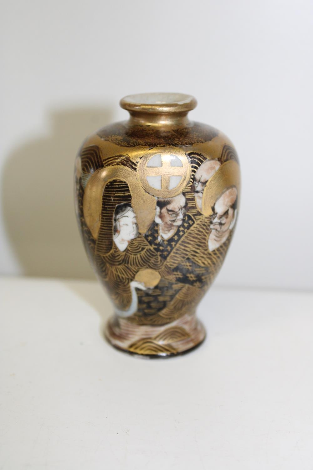 A small Japanese Meiji period Satsuma ware hand painted vase. Height 9cm