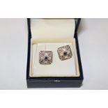 A pair of Royal Mint Victoria Cross earrings with sapphire detail