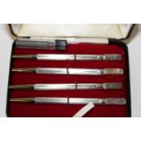 A boxed set of four silver bridge pencils