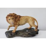 A large Beswick lion figure 29cm x 22cm