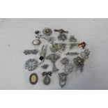 Twenty assorted costume brooches