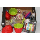 A box of brand new kitchen items, jelly moulds and cutters etc