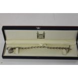 A Royal Mint diamond & sapphire pendant & silver T Bar chain