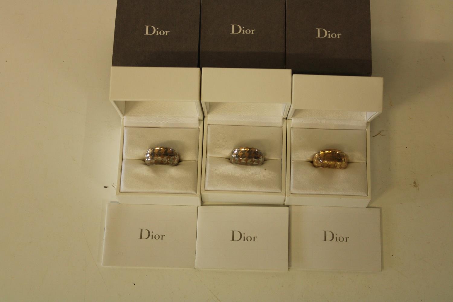 Three boxed Dior designer rings