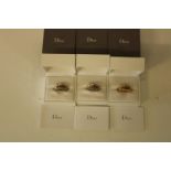 Three boxed Dior designer rings