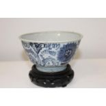 A Chinese porcelain bowl on a wooden stand circa 17th century (sold as seen)14cm in diameter.