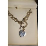 A Royal Mint sapphire & diamond heart shaped pendant with silver T Bar chain