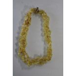 A yellow amber three strand necklace