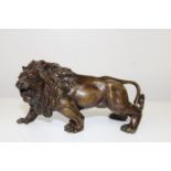 A bronze lion figure 25cm x 9cm