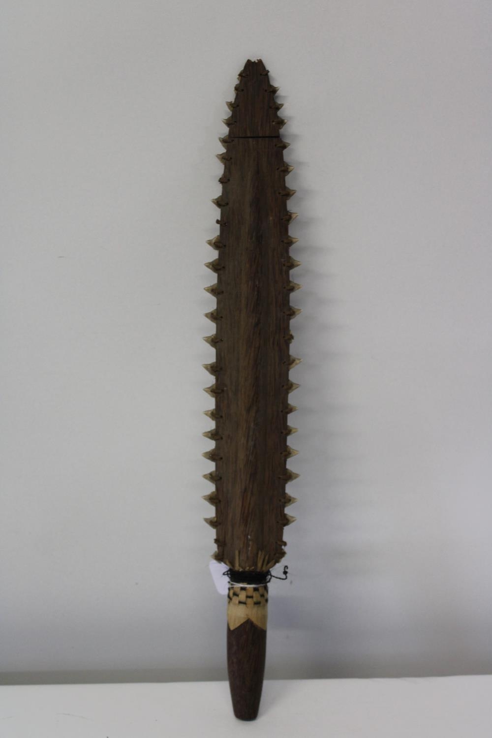 An unusual tribal club, with sharks teeth on both sides, possibly Moari or Polynesian. 54cm in