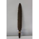 An unusual tribal club, with sharks teeth on both sides, possibly Moari or Polynesian. 54cm in