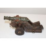 A working bronze canon with good patination to the barrel & cart. 21cm x 9cm