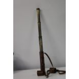 A Victorian three draw brass telescope with leather case 69cm when extended