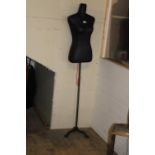 A mannequin torso on a cast iron stand Height 1.63 mtr