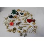 A selection of fifty vintage brooches