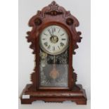 An antique American Ginger Bread striking mantel clock in GWO. Height 51cm x 36cm wide