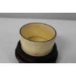 A 19th century Chinese ivory & tortoise shell brush pot on a wooden stand 8cm x 10cm