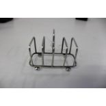 A hallmarked silver four slice toast rack Sheffield 1902 9x8cm