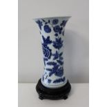 A Chinese porcelain blue & white beaker vase with character marks hidden in foilage. Sold as seen