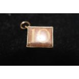 A 9ct gold 10 shilling charm