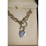 A Royal Mint sapphire & diamond heart shaped pendant with hallmarked silver T Bar chain