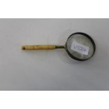 A vintage bone handled magnifying glass 16cm tall