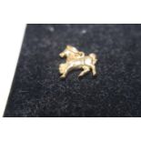 A 9ct gold horse themed charm