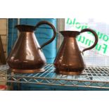 Two graduated copper jugs h29cm & h25cm