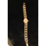 A Ladies 9ct gold bodied watch & strap 13.1 grams in total