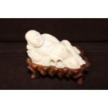 An antique hand carved ivory Immortal figure. 7cm in length