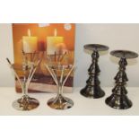 Two pairs of metal candlesticks. One new and boxed.