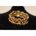 A gilt purple stoned & paste bracelet