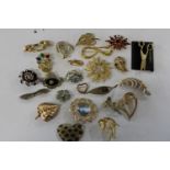 A large selection of vintage brooches