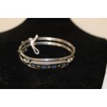A white metal & blue stone bracelet